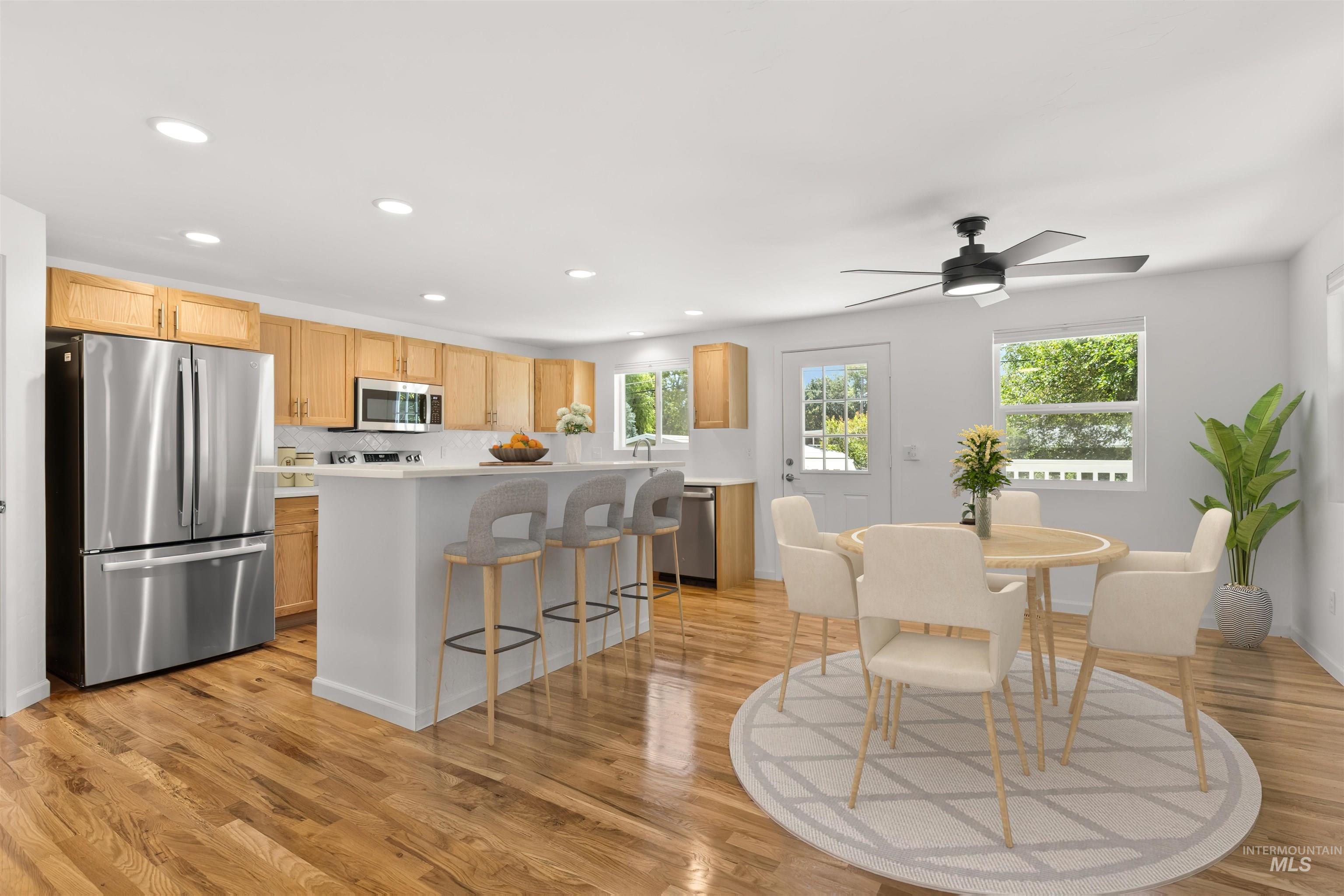 Dining area featuring recessed lighting, light wood-style floors, and a ceiling fan