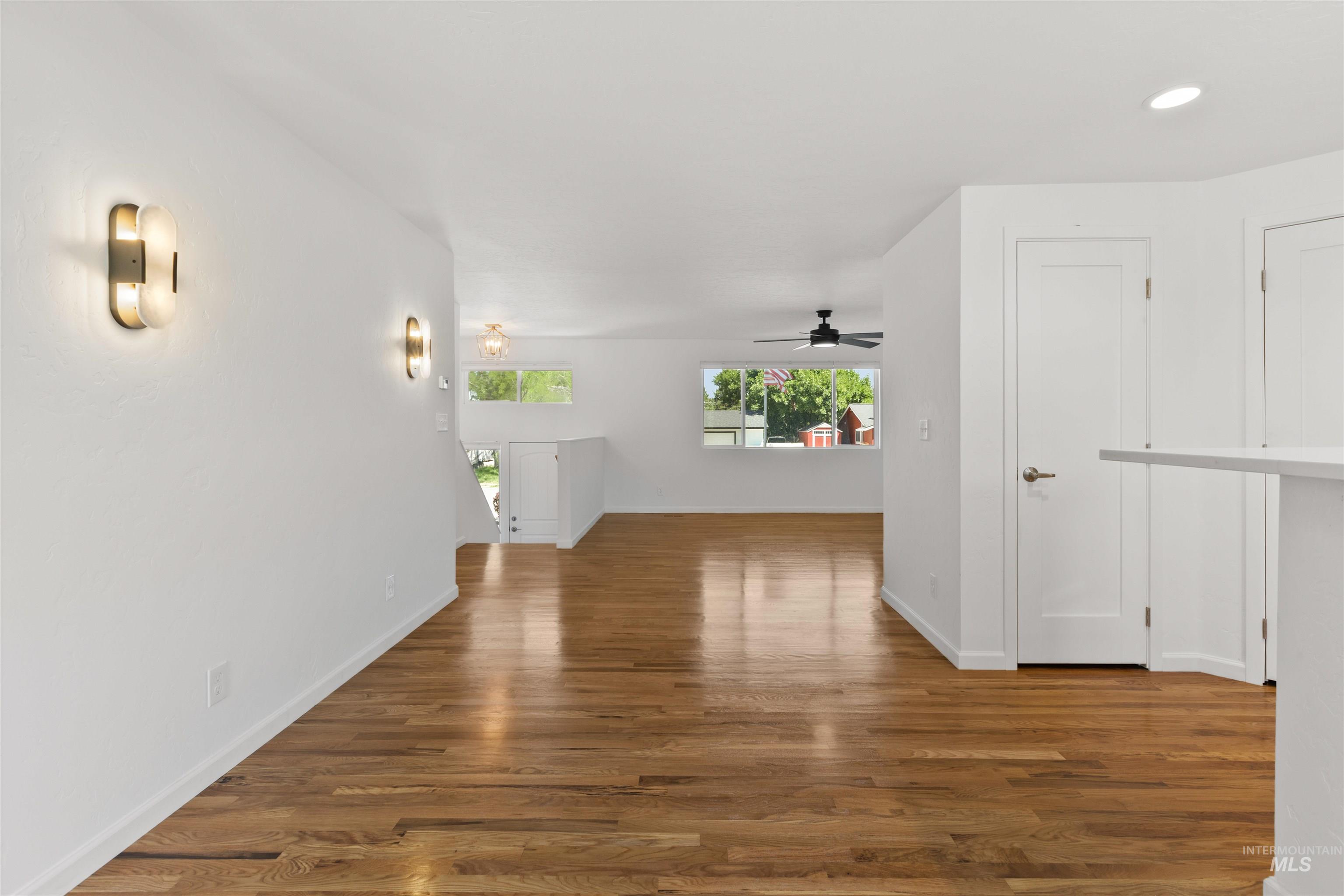 Hallway featuring wood finished floors and recessed lighting