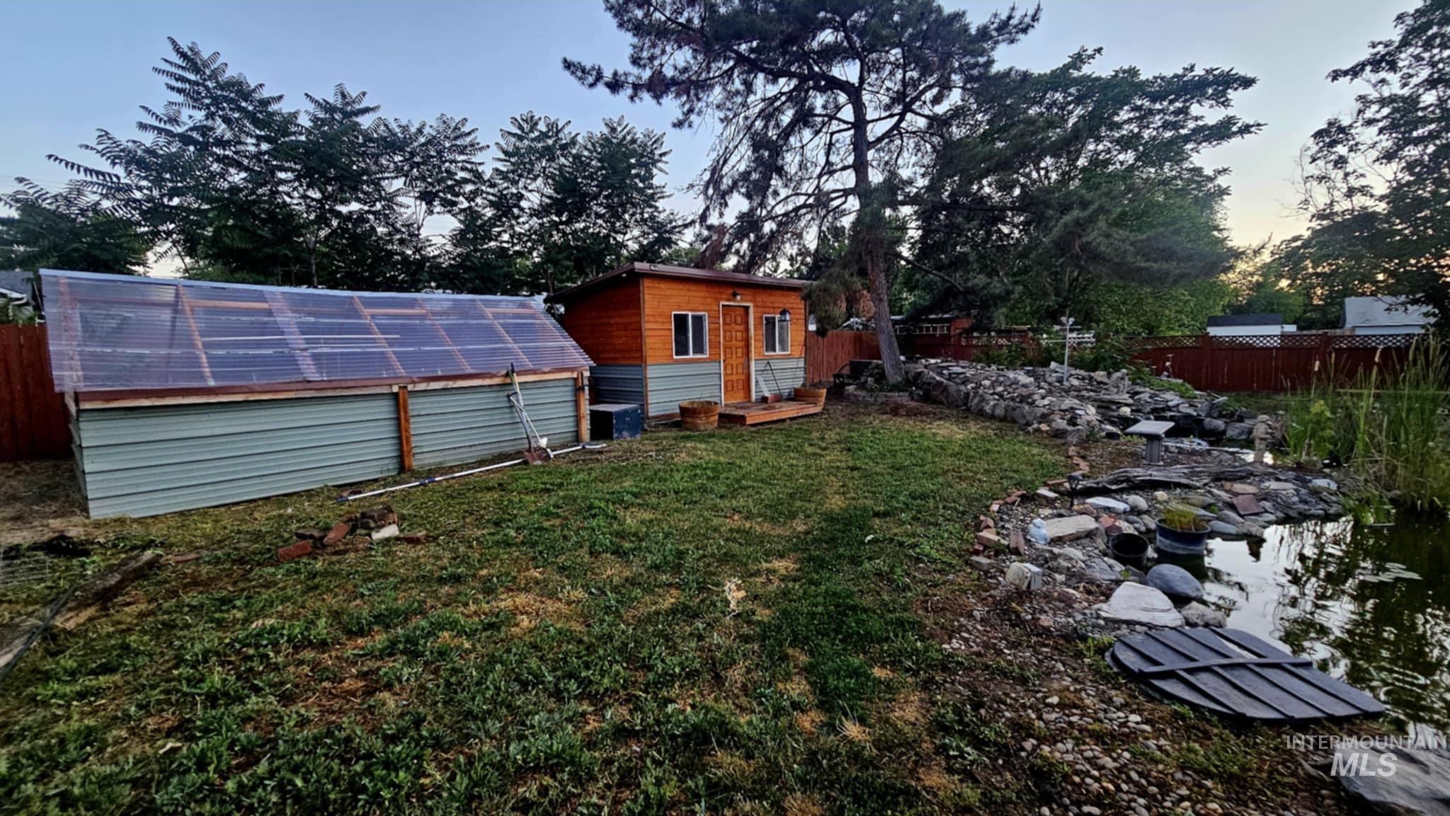 View of yard with an exterior structure, an outdoor structure, and a garage