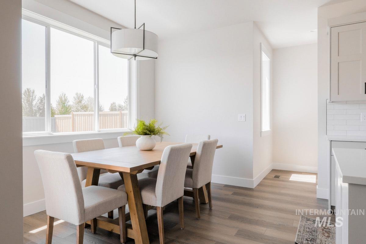 Dining room with plenty of natural light and light wood-style flooring