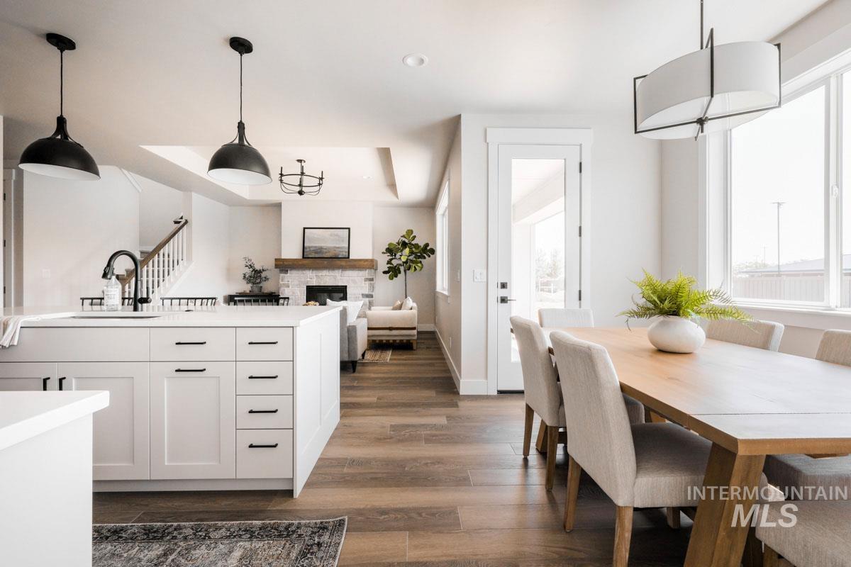 Kitchen with dark wood-style floors, plenty of natural light, a fireplace, and light countertops