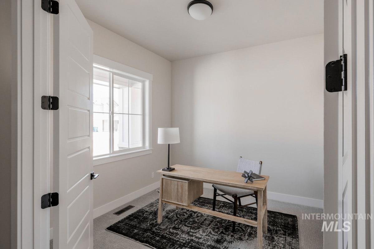 Carpeted office featuring baseboards