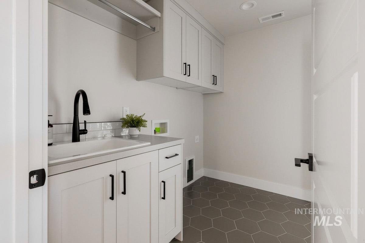 Laundry area with hookup for a washing machine and cabinet space