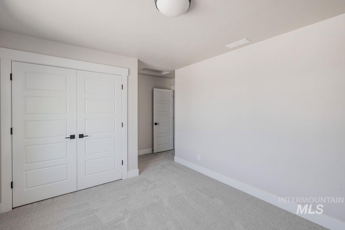 Unfurnished bedroom with carpet floors and a closet