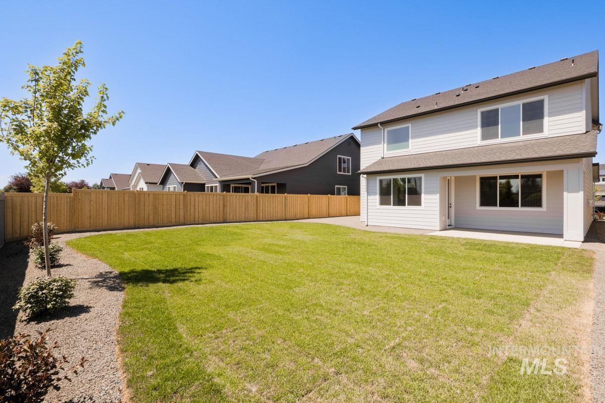 Fenced backyard with a residential view and a patio area