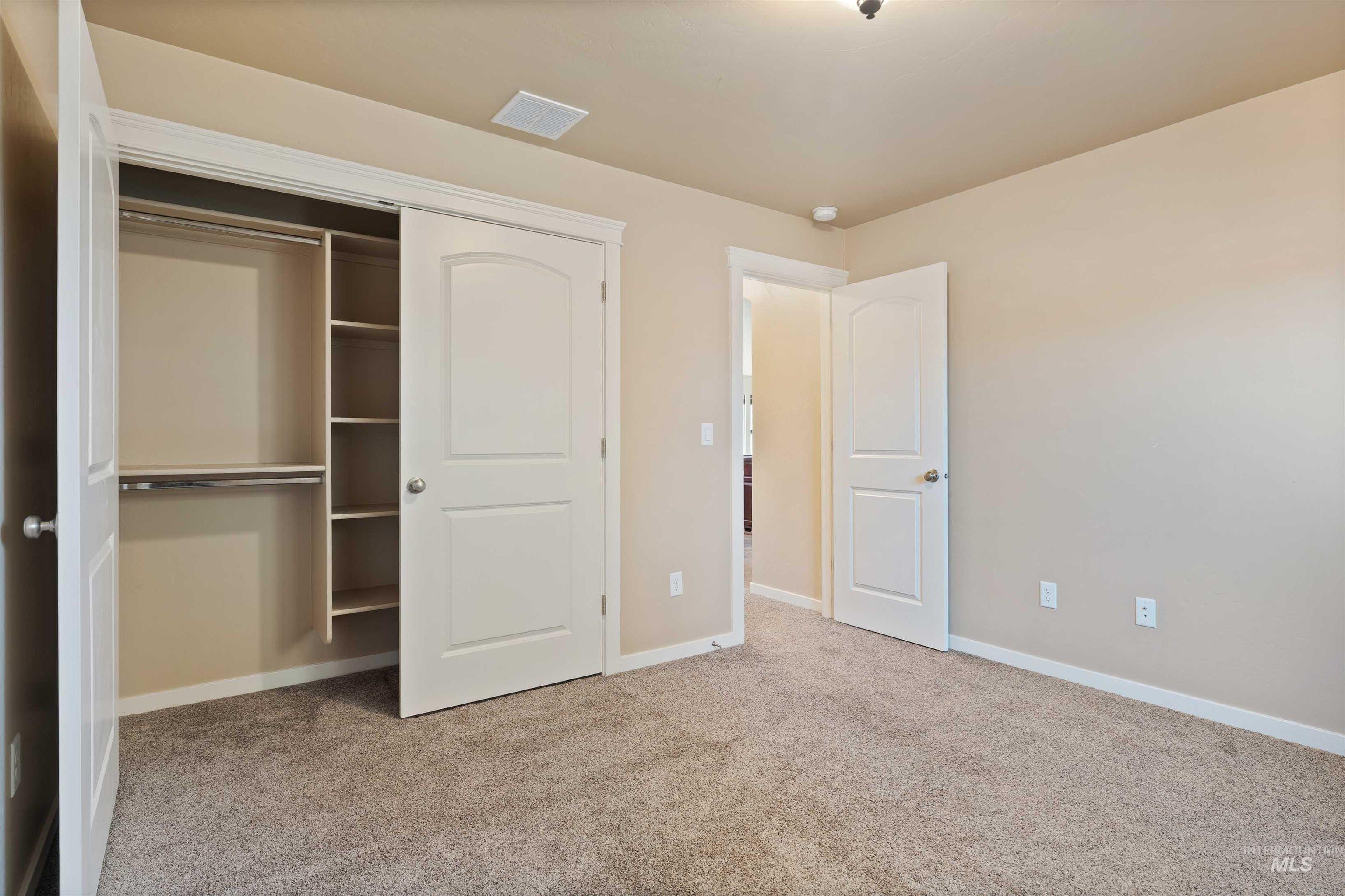 Unfurnished bedroom featuring carpet flooring and a closet