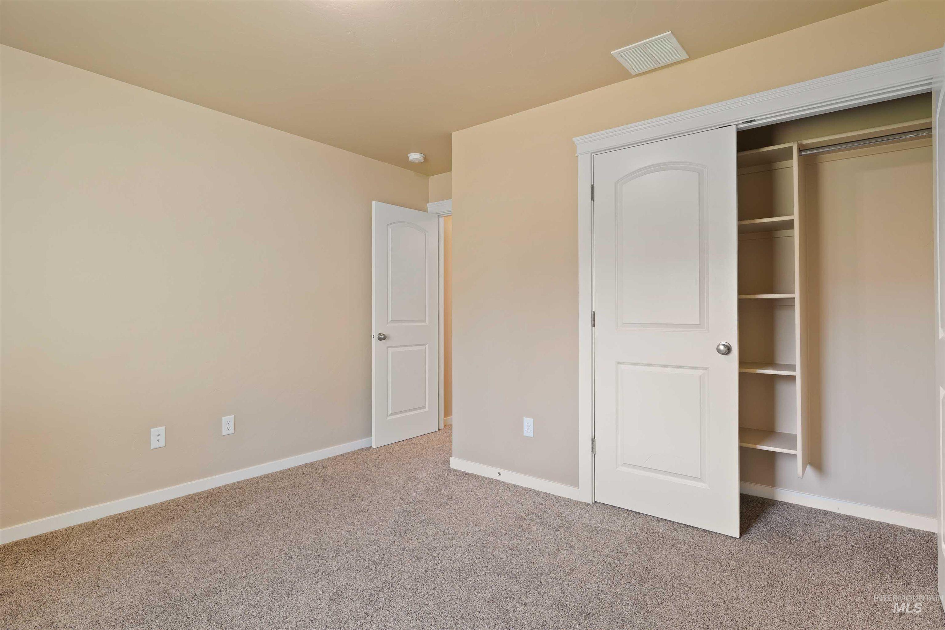 Unfurnished bedroom with carpet flooring and a closet