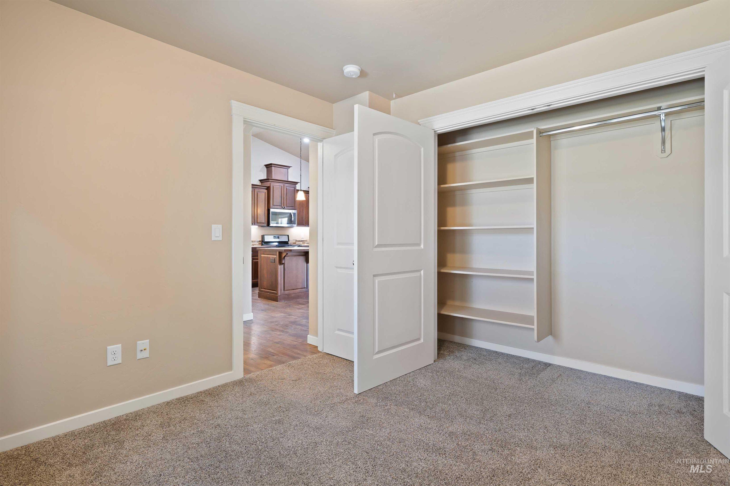 Unfurnished bedroom with carpet floors and a closet