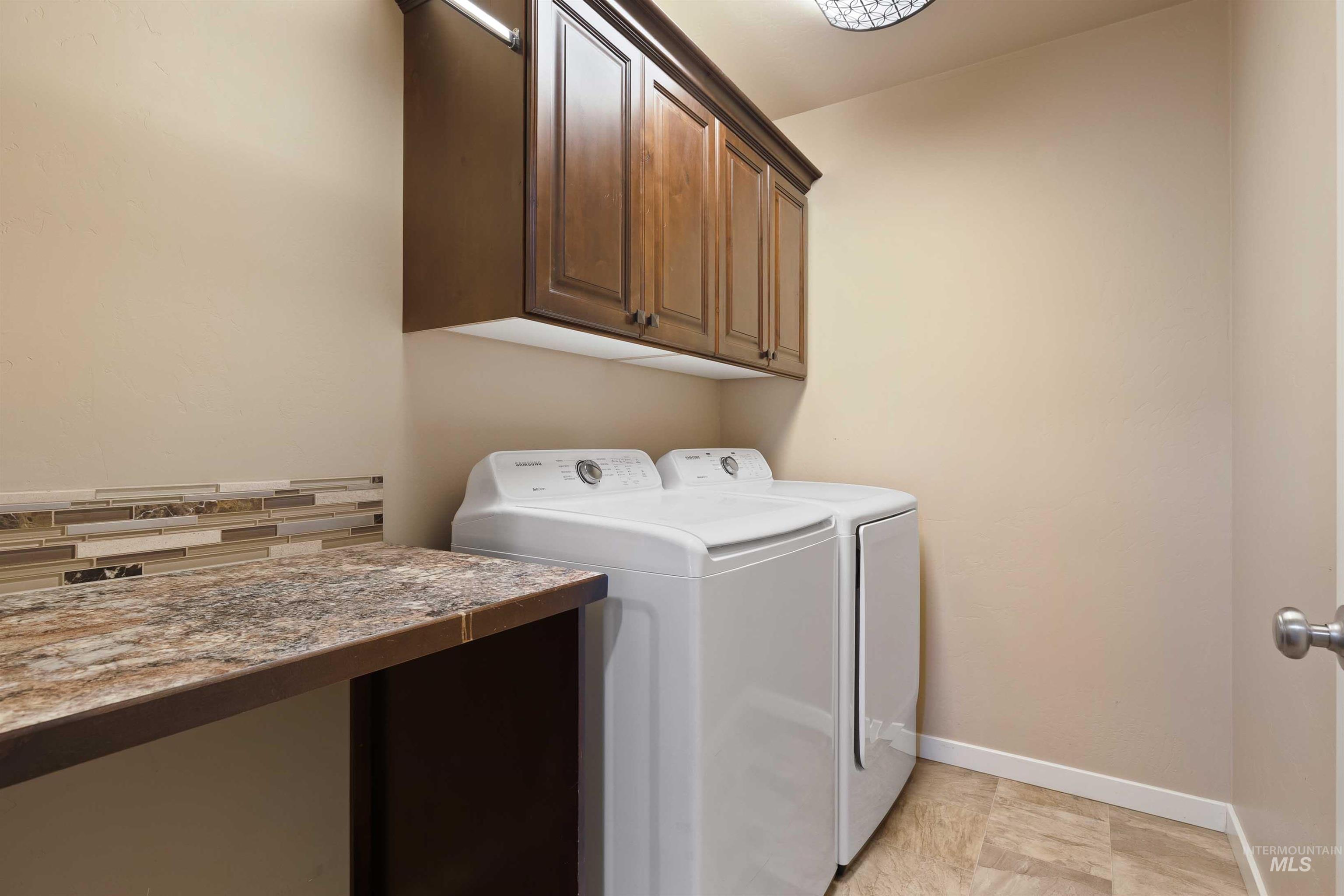 Laundry area with washing machine and dryer and cabinet space