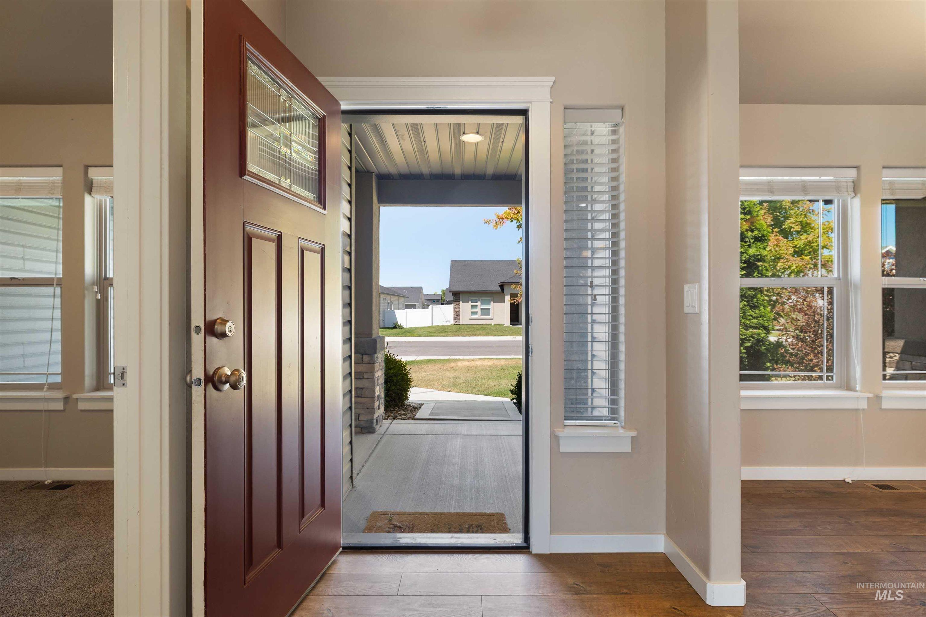 Entryway featuring baseboards and wood finished floors