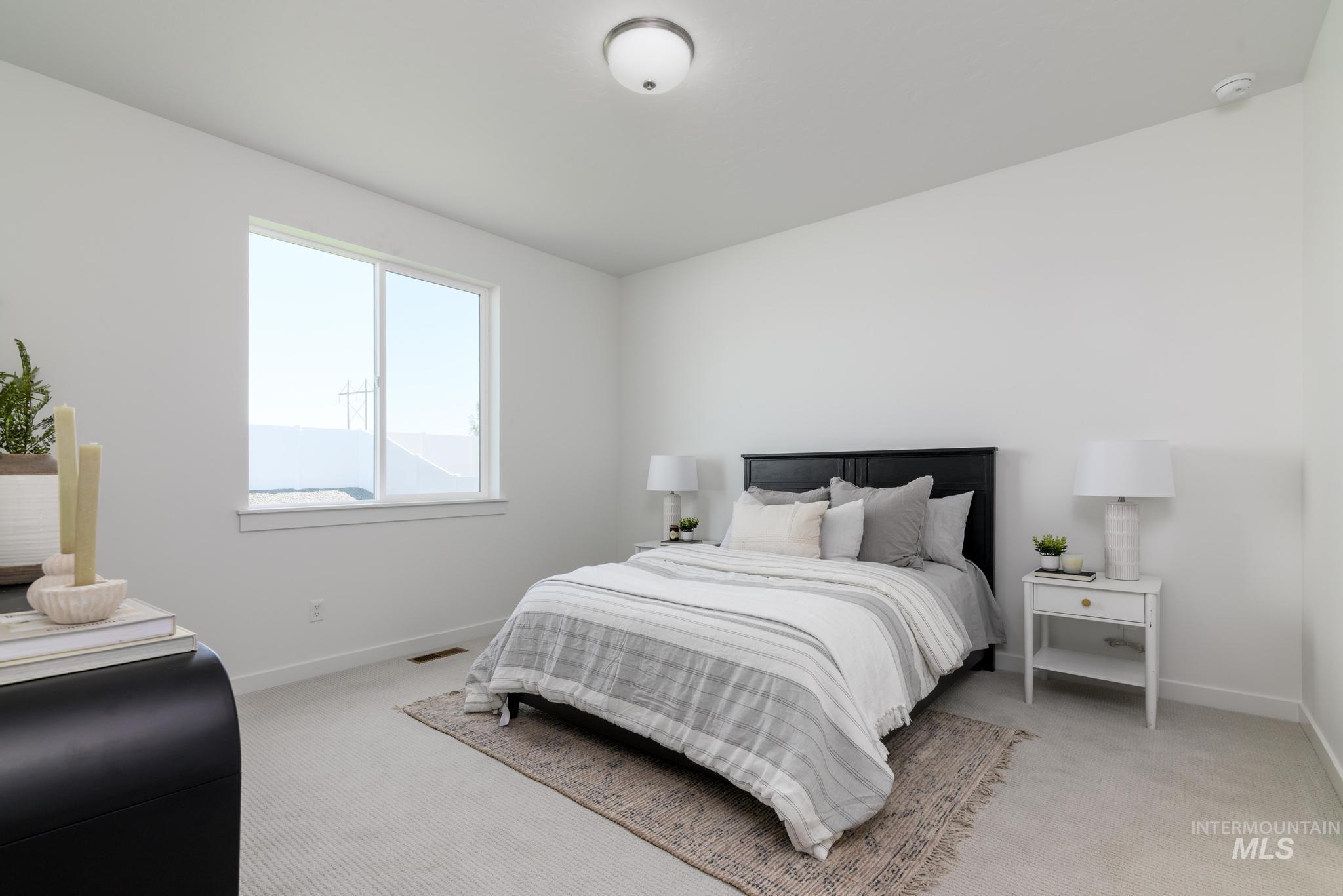 Bedroom featuring light colored carpet