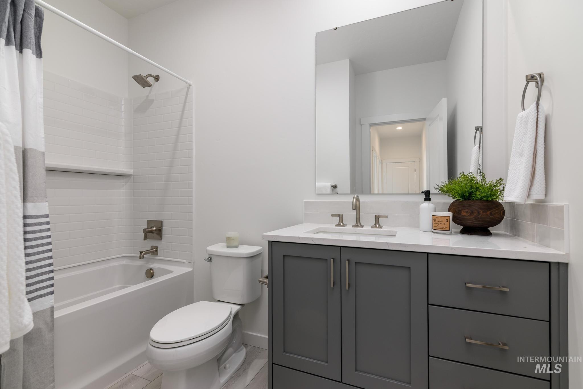 Full bathroom featuring vanity and shower / bathtub combination with curtain