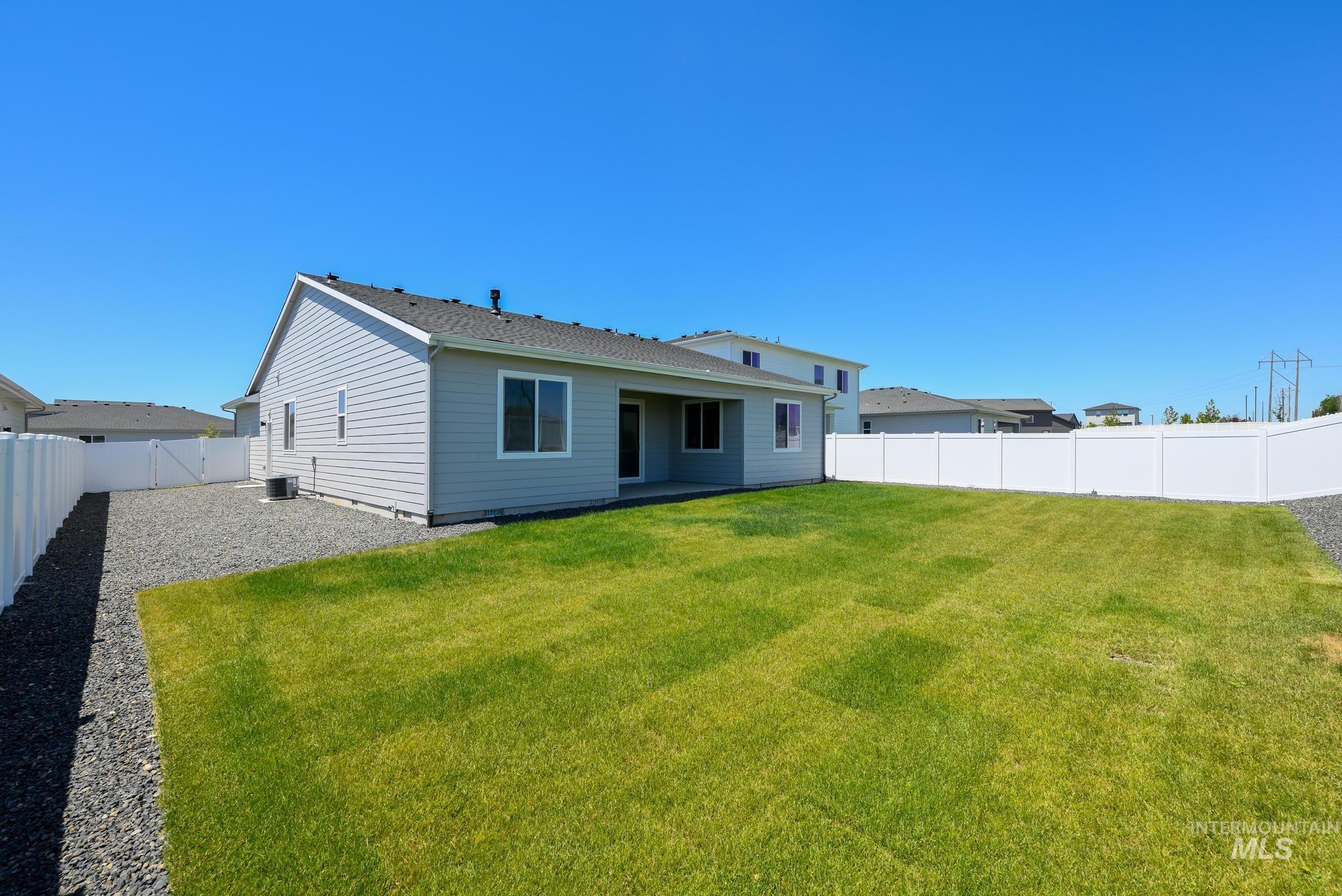 Rear view of house with a fenced backyard