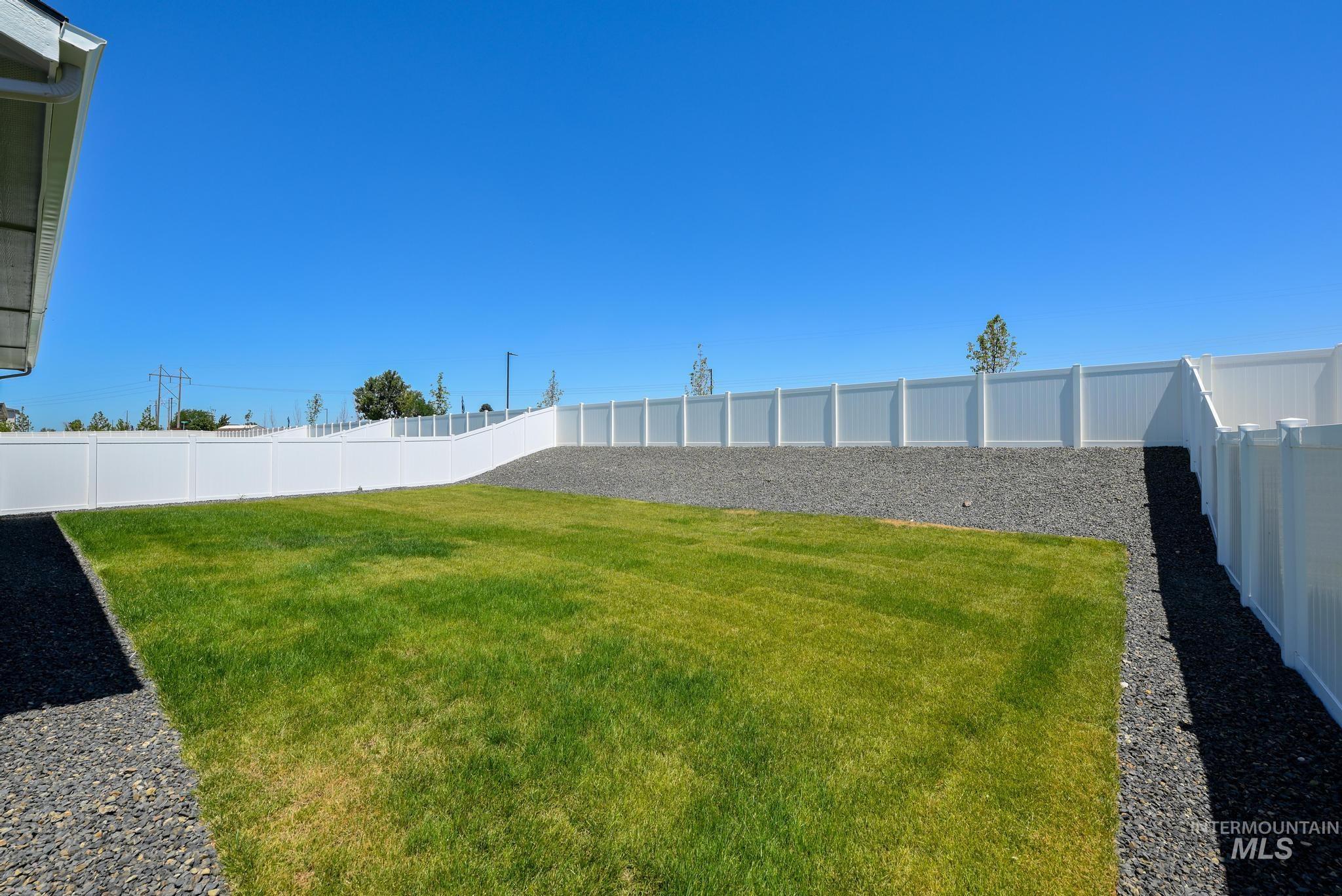 View of fenced backyard