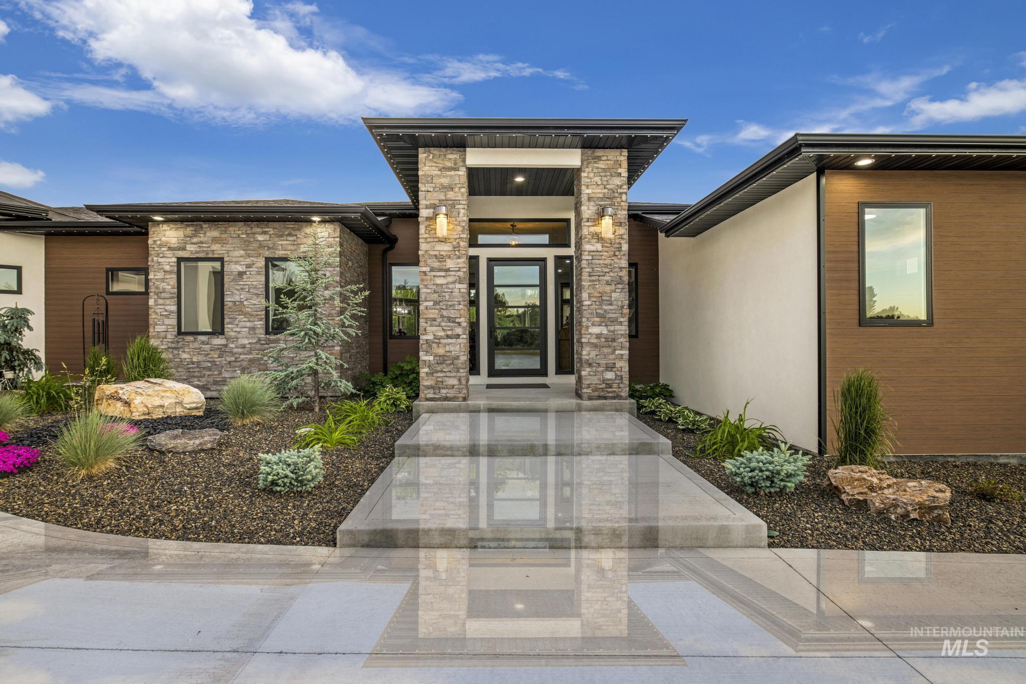 Entrance to property featuring stone siding and stucco siding