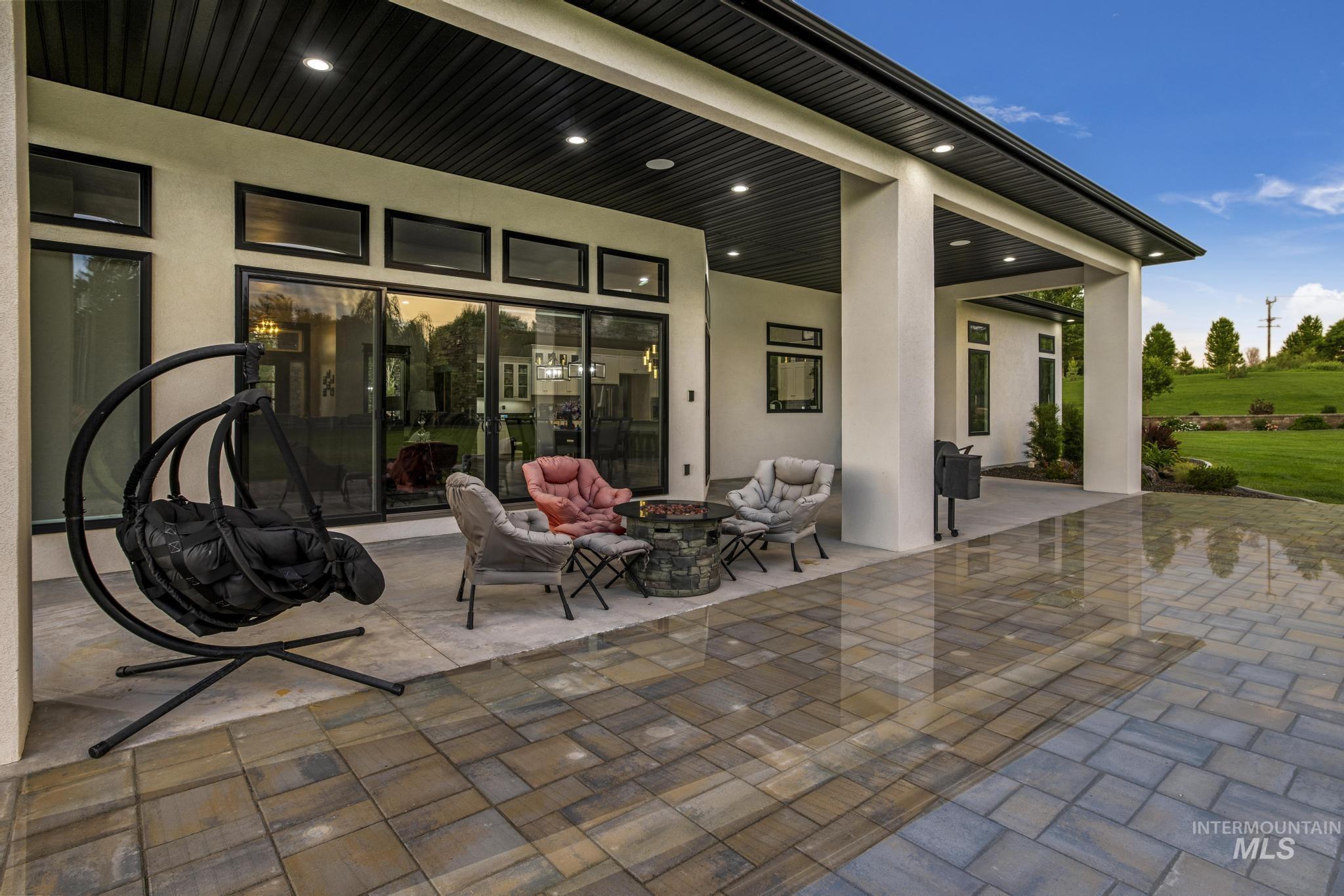 View of patio with a fire pit