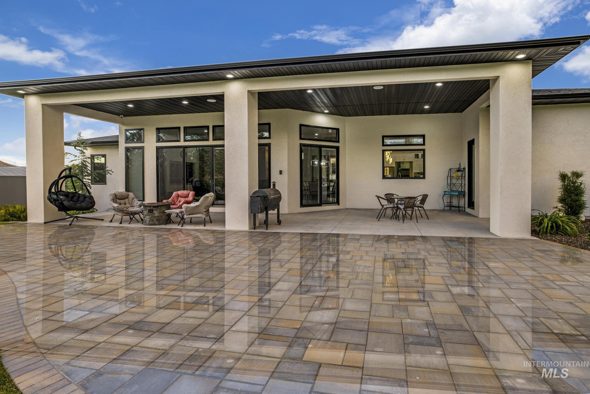 Back of property with a patio and stucco siding