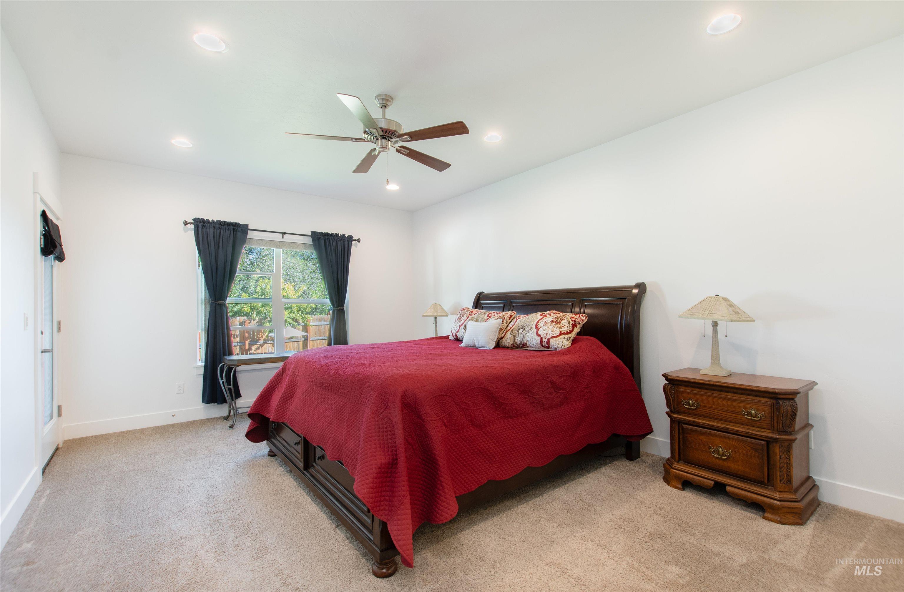 Bedroom with carpet floors, ceiling fan, and recessed lighting