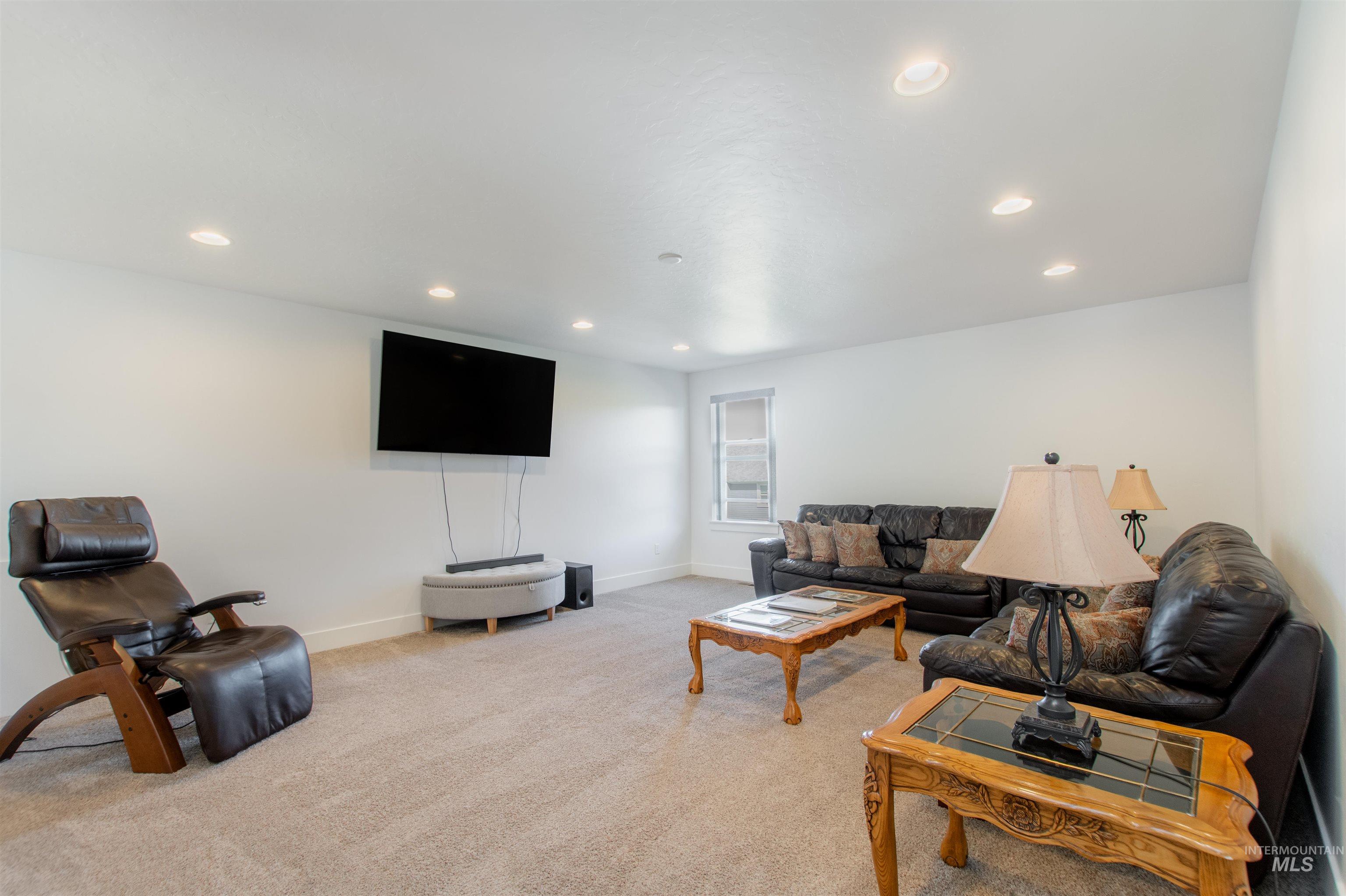 Living room featuring light carpet and recessed lighting