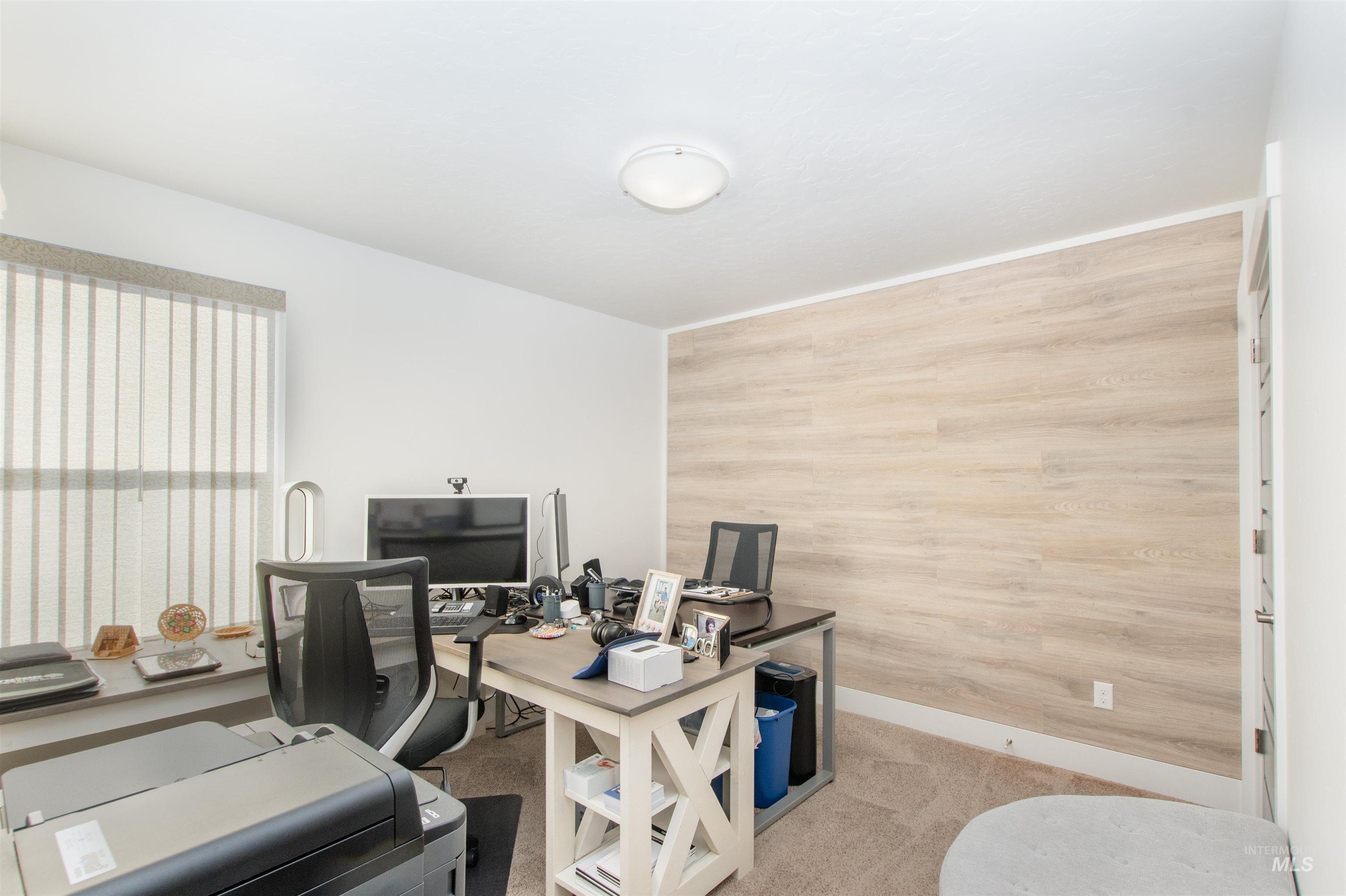 Carpeted office space featuring baseboards