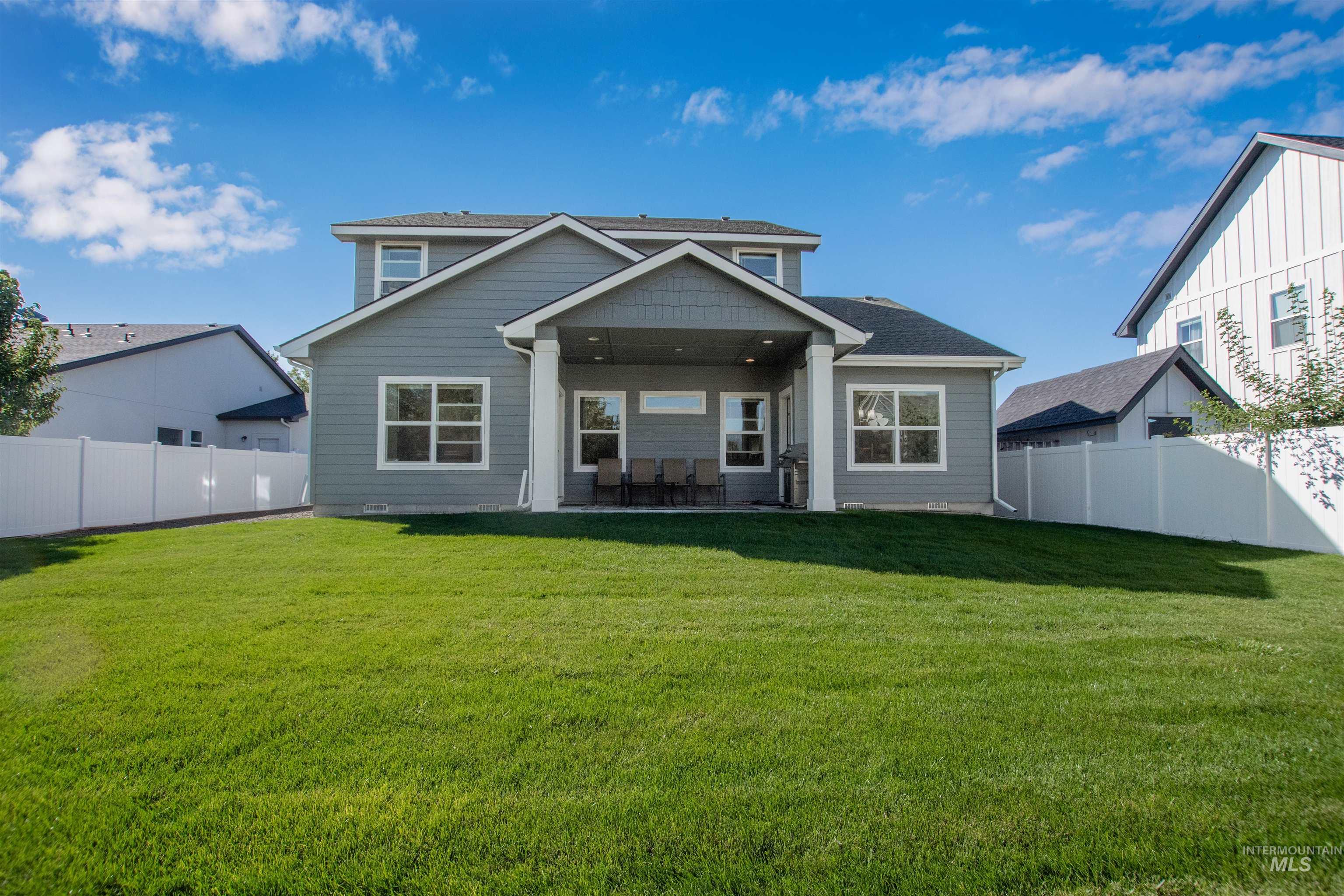 Rear view of property featuring a patio and a fenced backyard