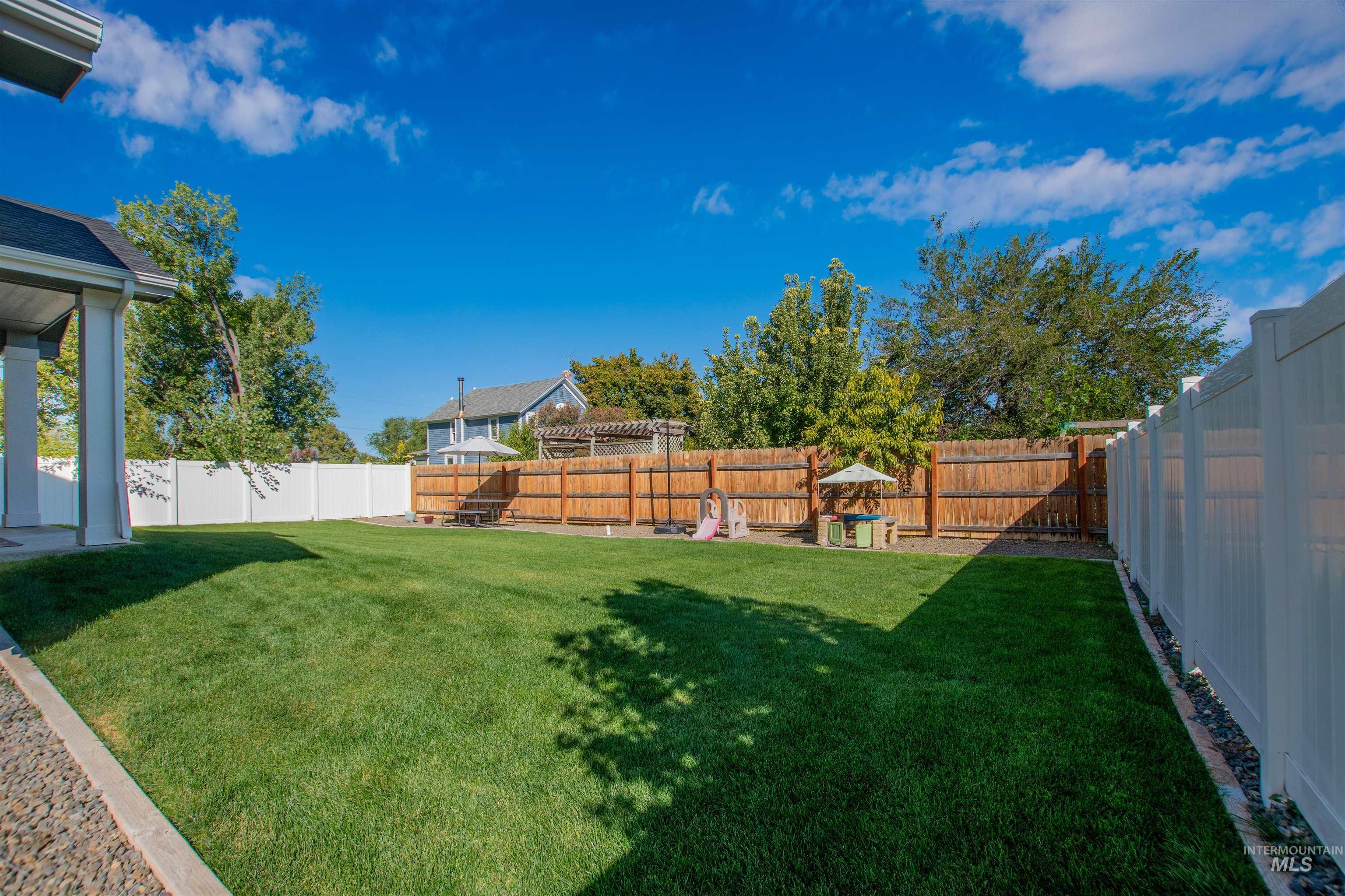 Fenced backyard with a patio area