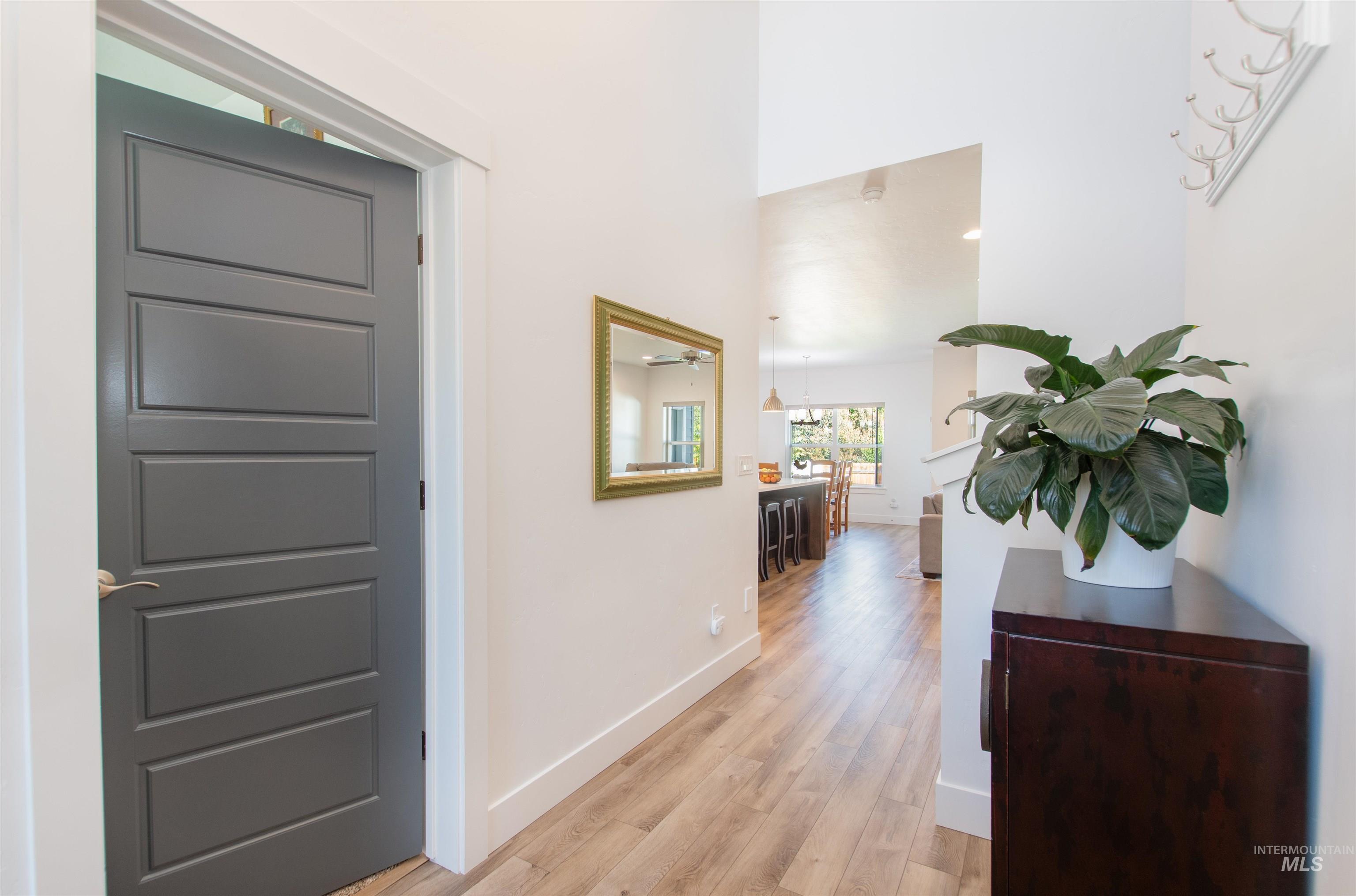 Hallway with light wood-style flooring and recessed lighting