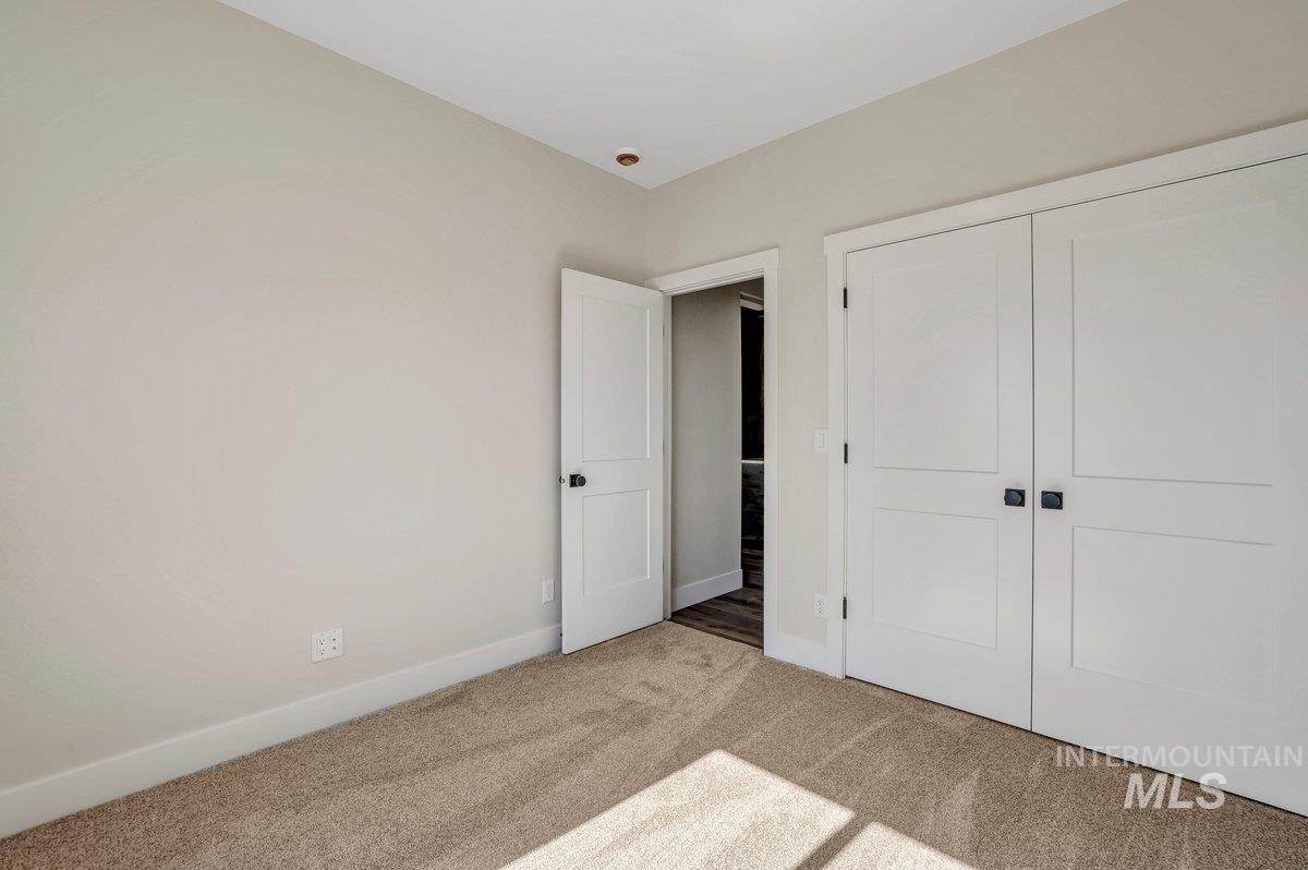 Unfurnished bedroom featuring carpet and a closet