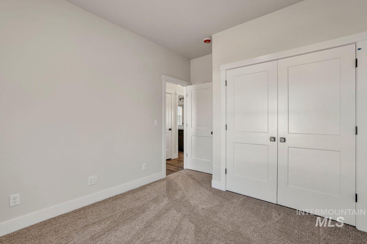 Unfurnished bedroom featuring carpet floors and a closet