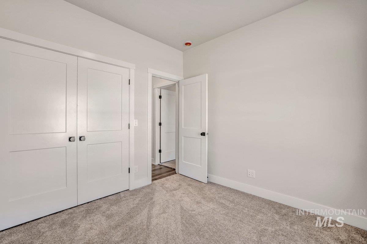 Unfurnished bedroom with carpet and a closet