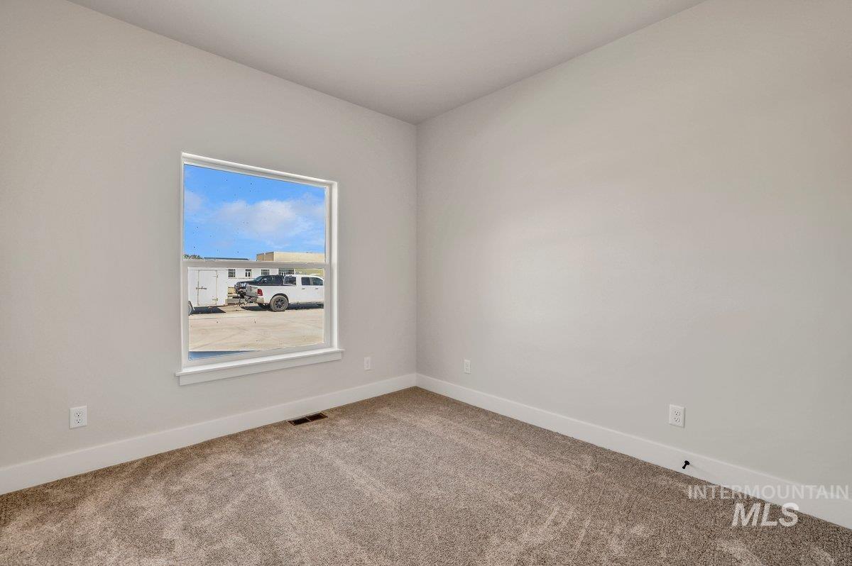 Unfurnished room featuring carpet floors and baseboards