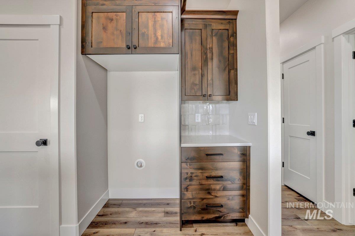 Kitchen featuring light wood-style floors, tasteful backsplash, and light countertops