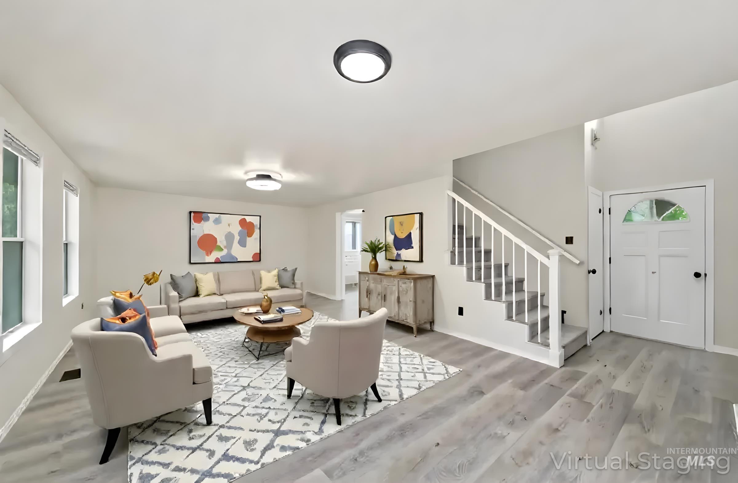 Living area featuring light wood-style flooring and stairs
