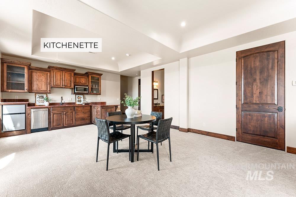 Dining area featuring light carpet, a raised ceiling, and recessed lighting