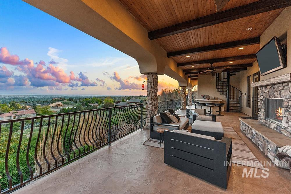 View of patio featuring an outdoor living space with a fireplace and ceiling fan
