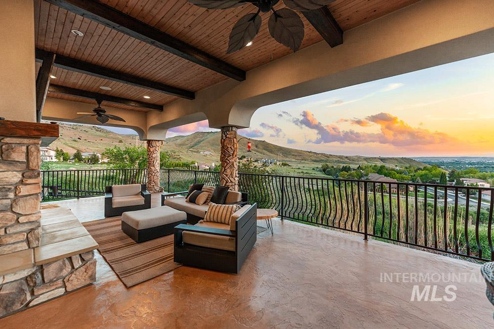 View of patio featuring a ceiling fan, an outdoor living space, and a mountain view
