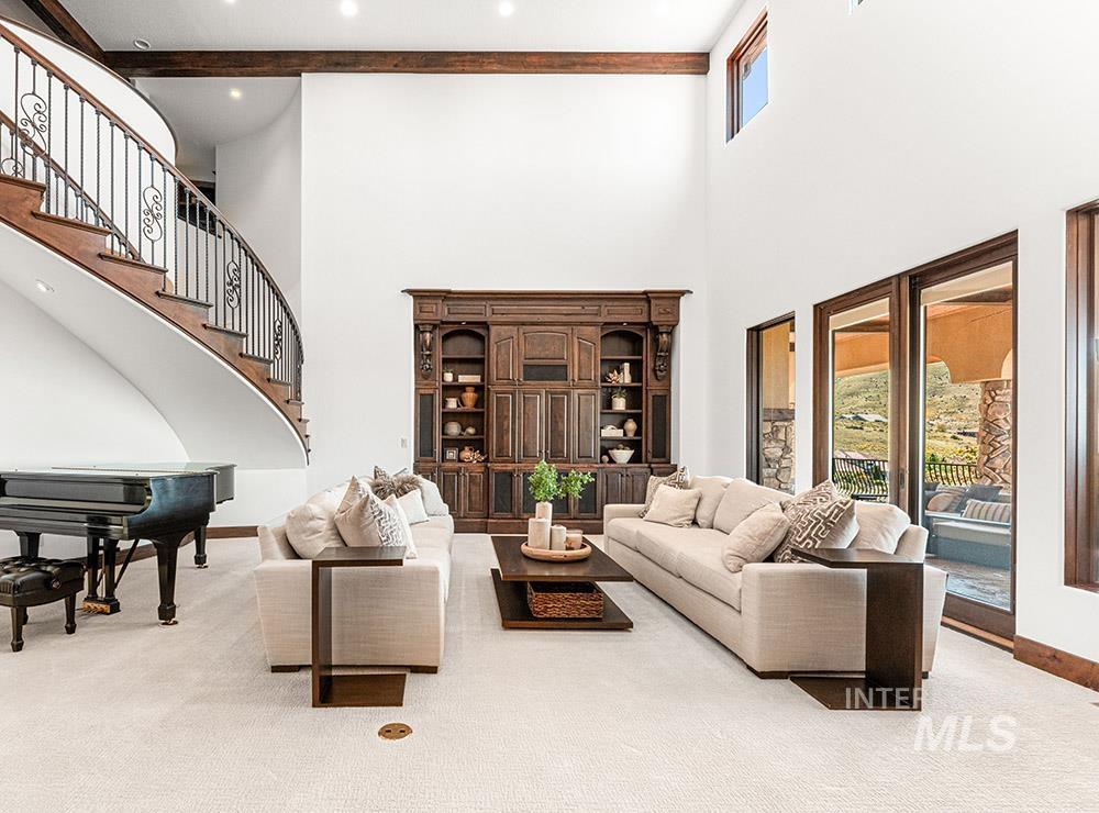 Living room with plenty of natural light, carpet floors, and stairs