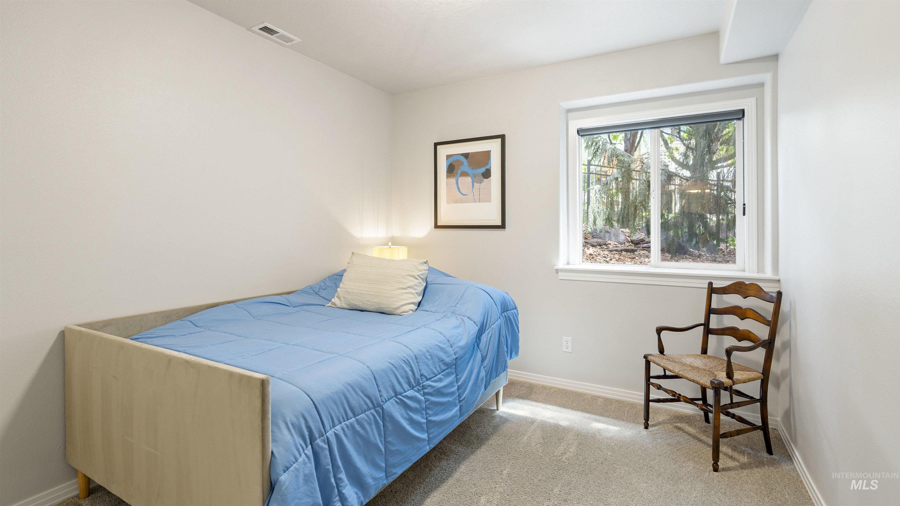 Bedroom with carpet flooring and baseboards