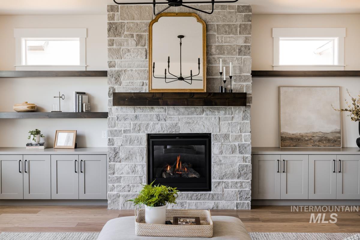 Living area featuring light wood-style flooring and a fireplace