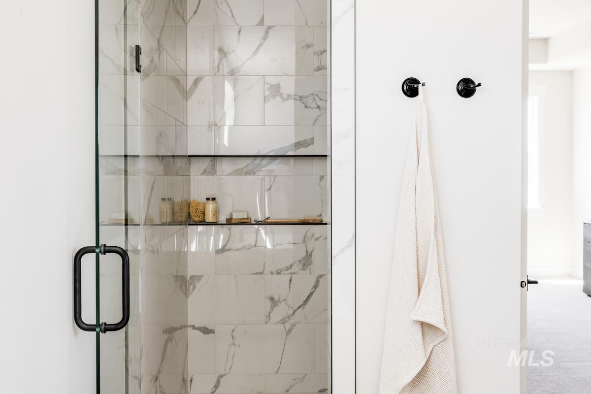Full bathroom featuring a marble finish shower