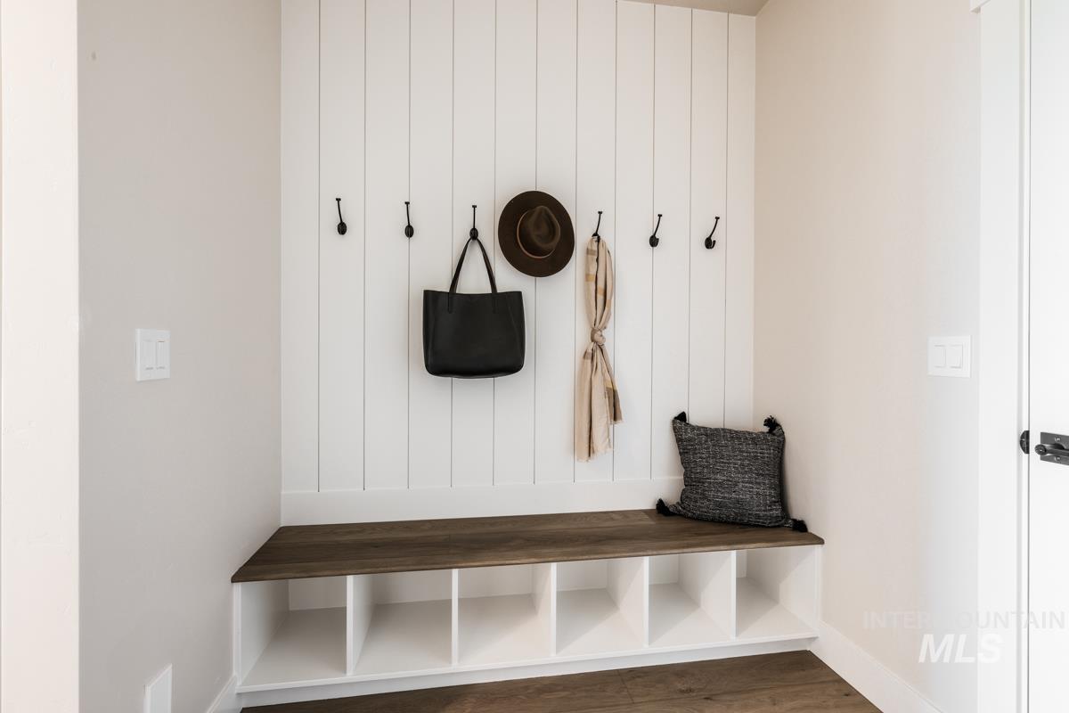 Mudroom featuring baseboards and wood finished floors