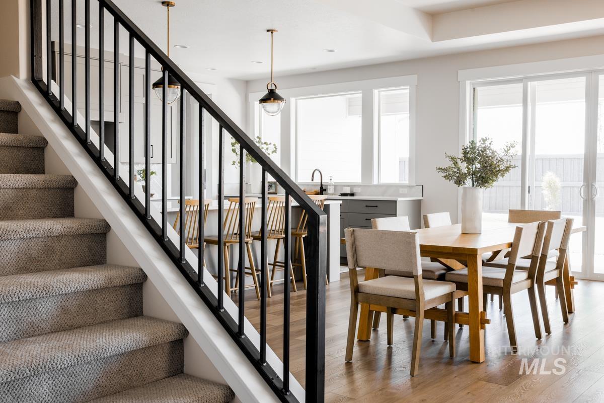 Staircase featuring wood finished floors and recessed lighting