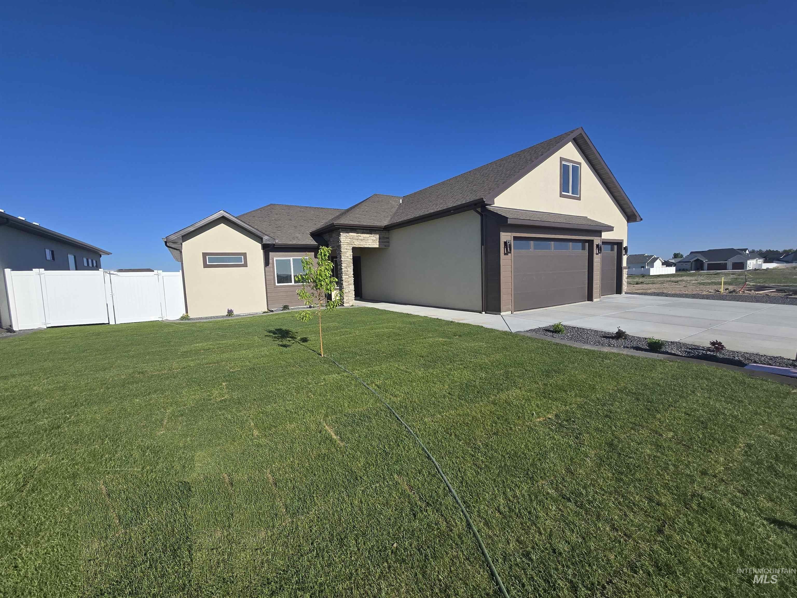 View of front of home featuring driveway, a garage, and stucco siding