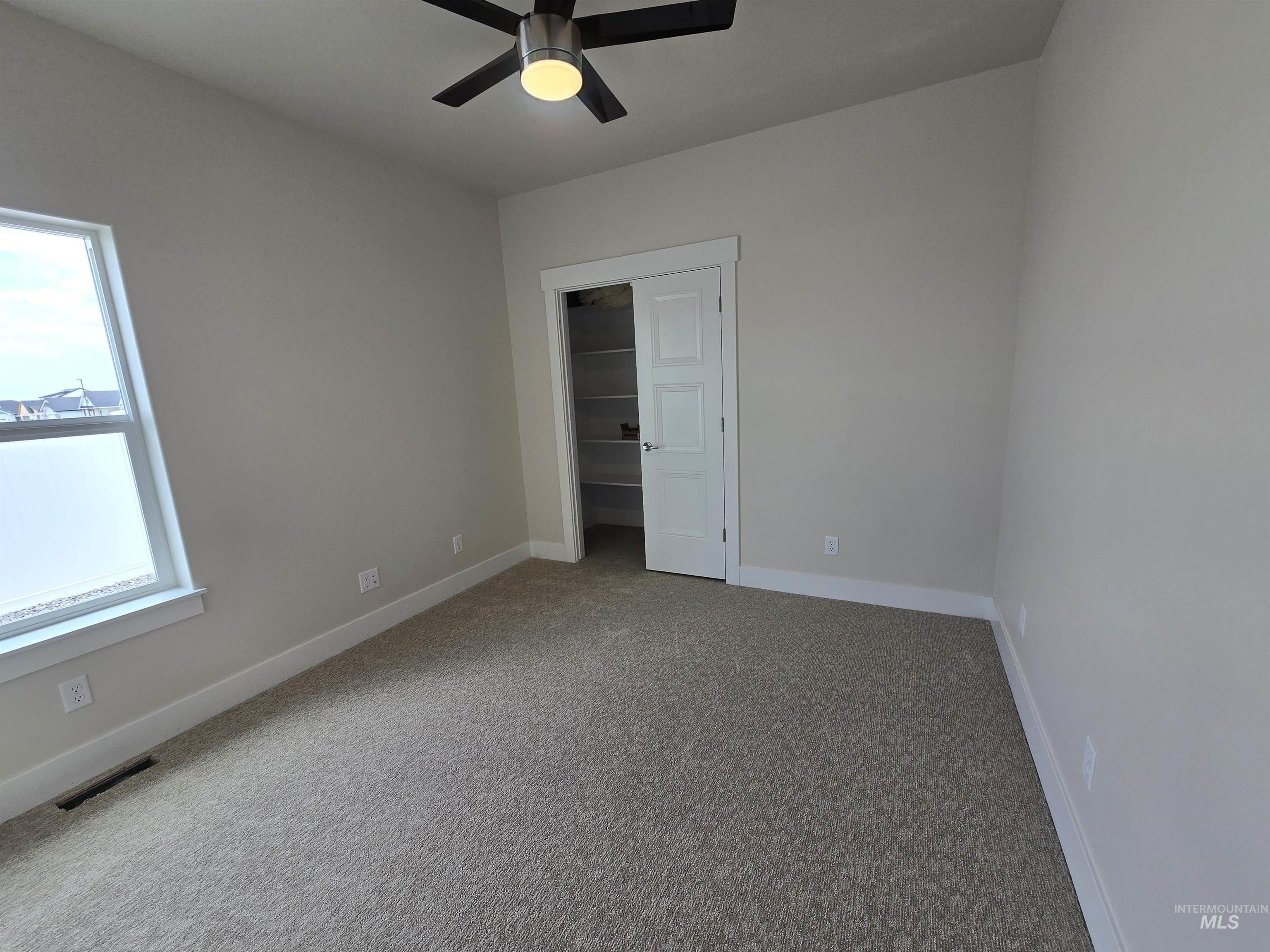 Unfurnished bedroom featuring a closet, carpet, and a ceiling fan