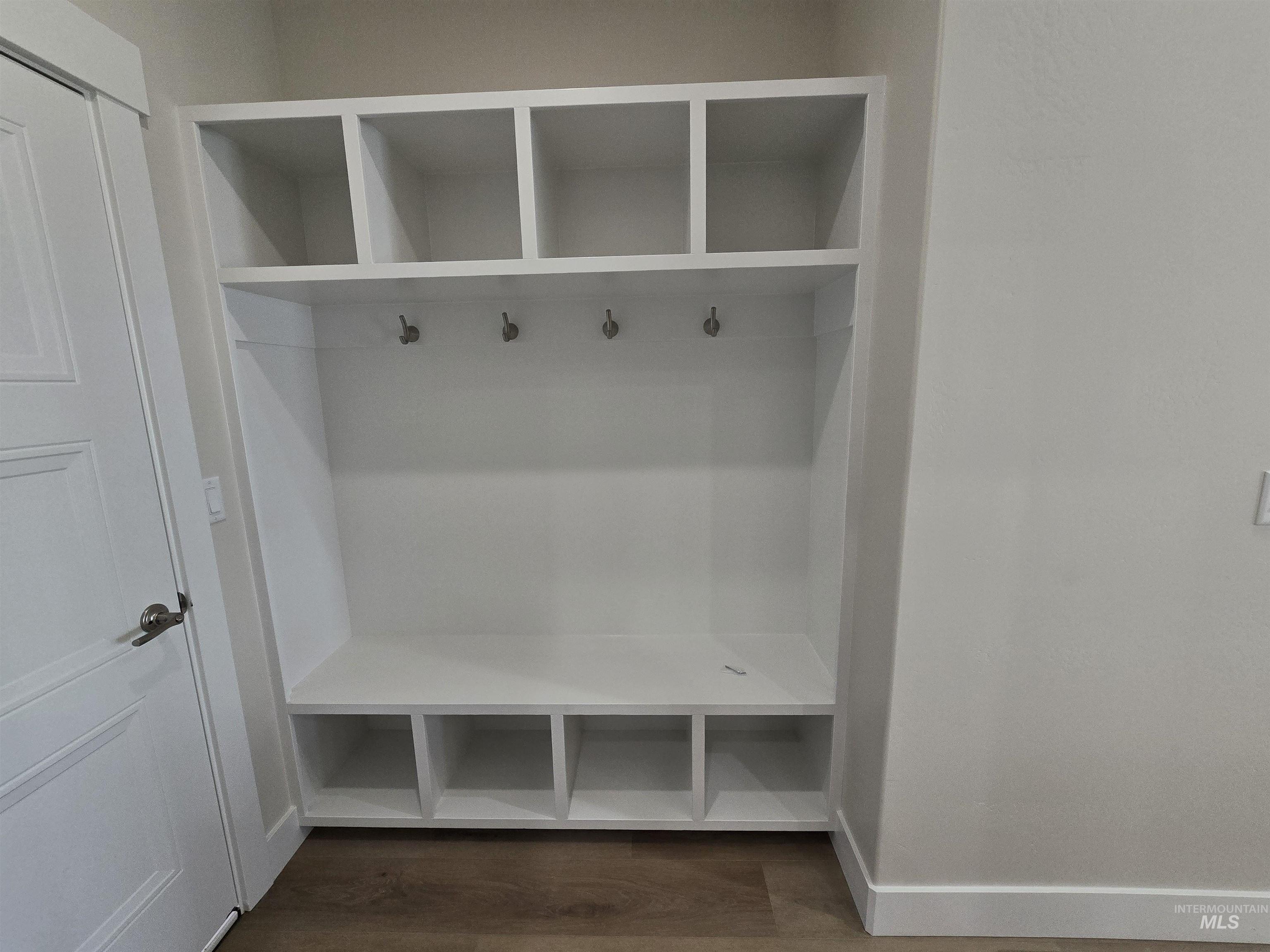 Mudroom featuring baseboards and dark wood finished floors