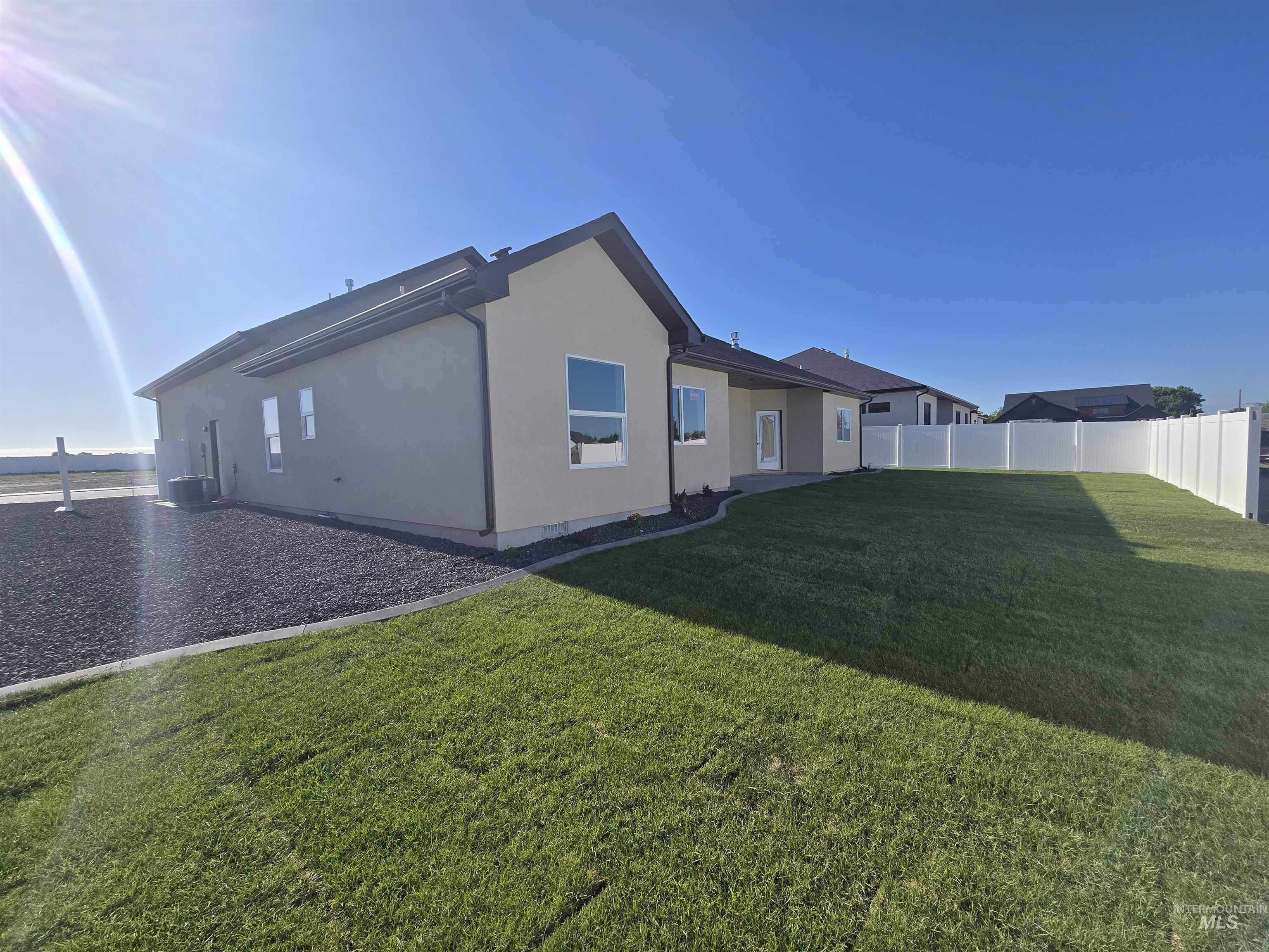 Rear view of house featuring stucco siding