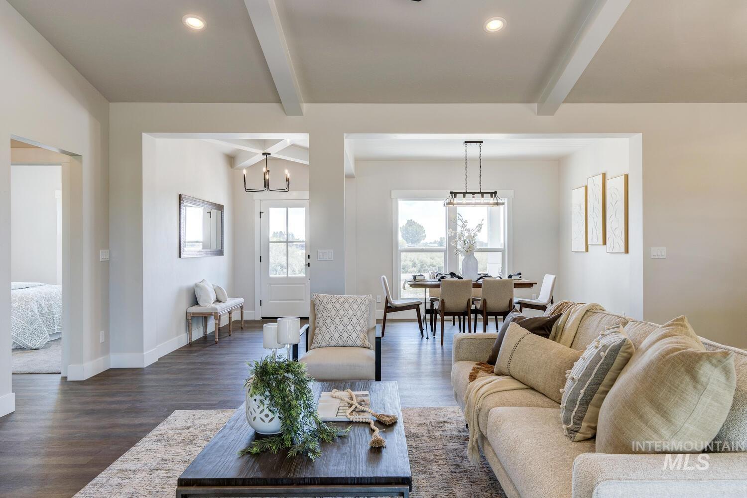 Living room featuring dark wood-style flooring, beam ceiling, recessed lighting, and a chandelier