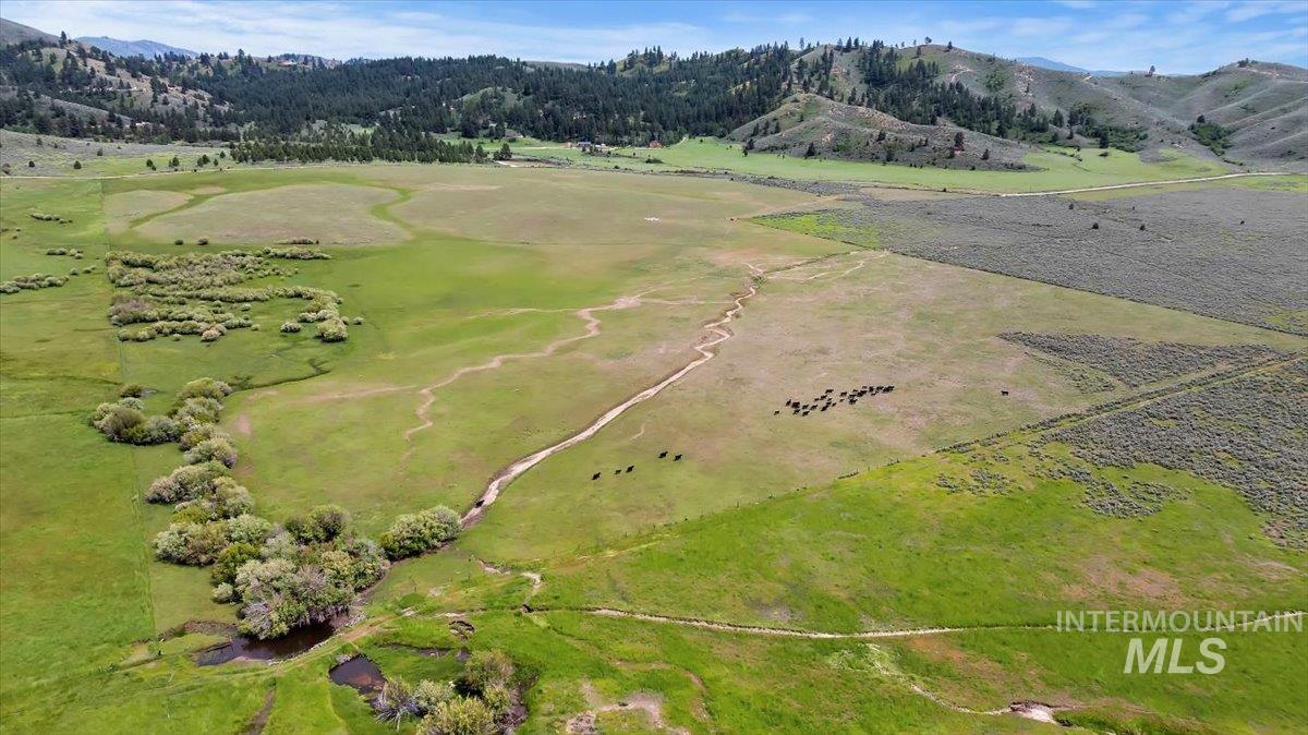 Aerial overview of property's location featuring a mountainous background