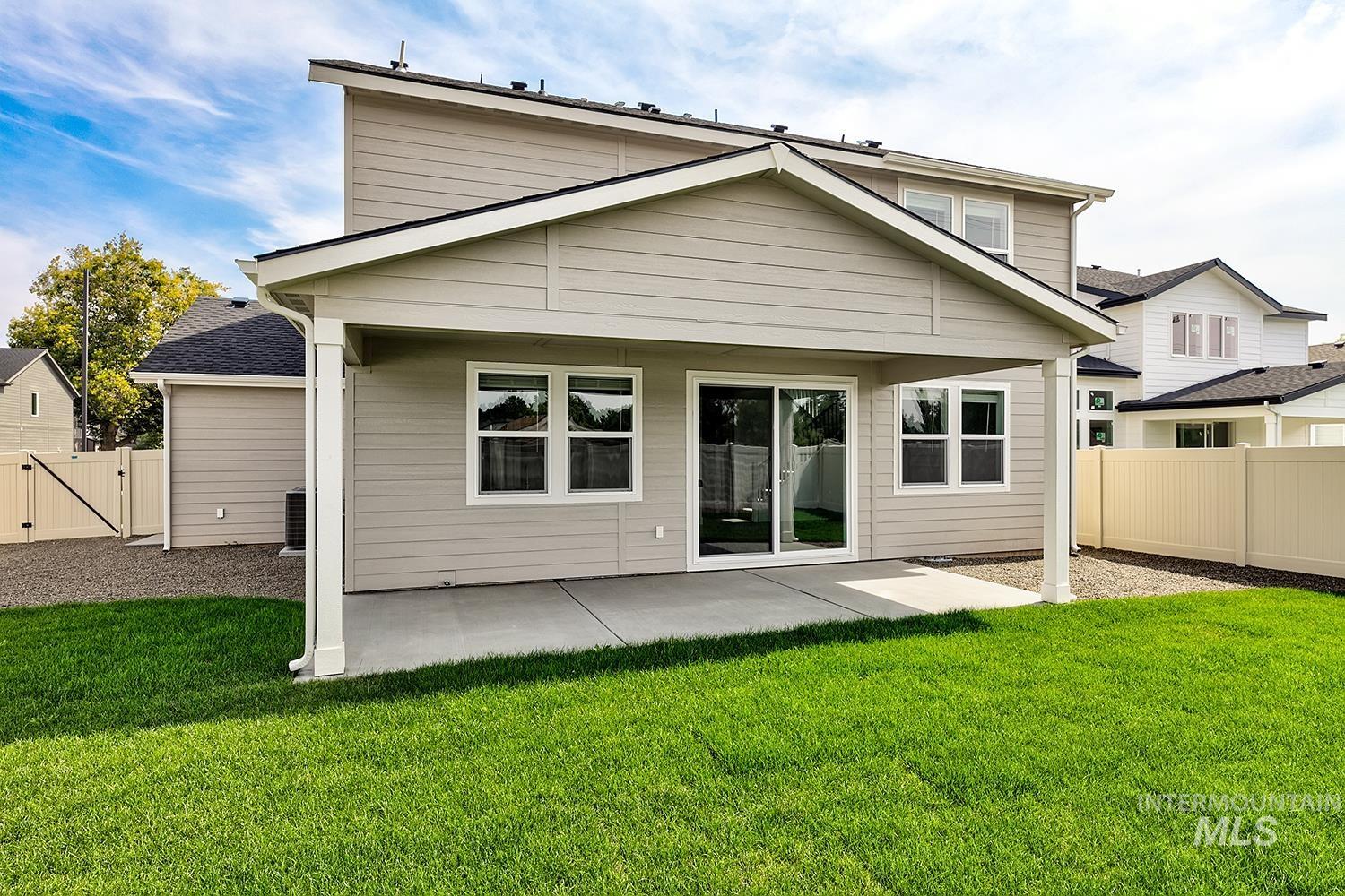 Rear view of house with a patio area, a fenced backyard, and a gate