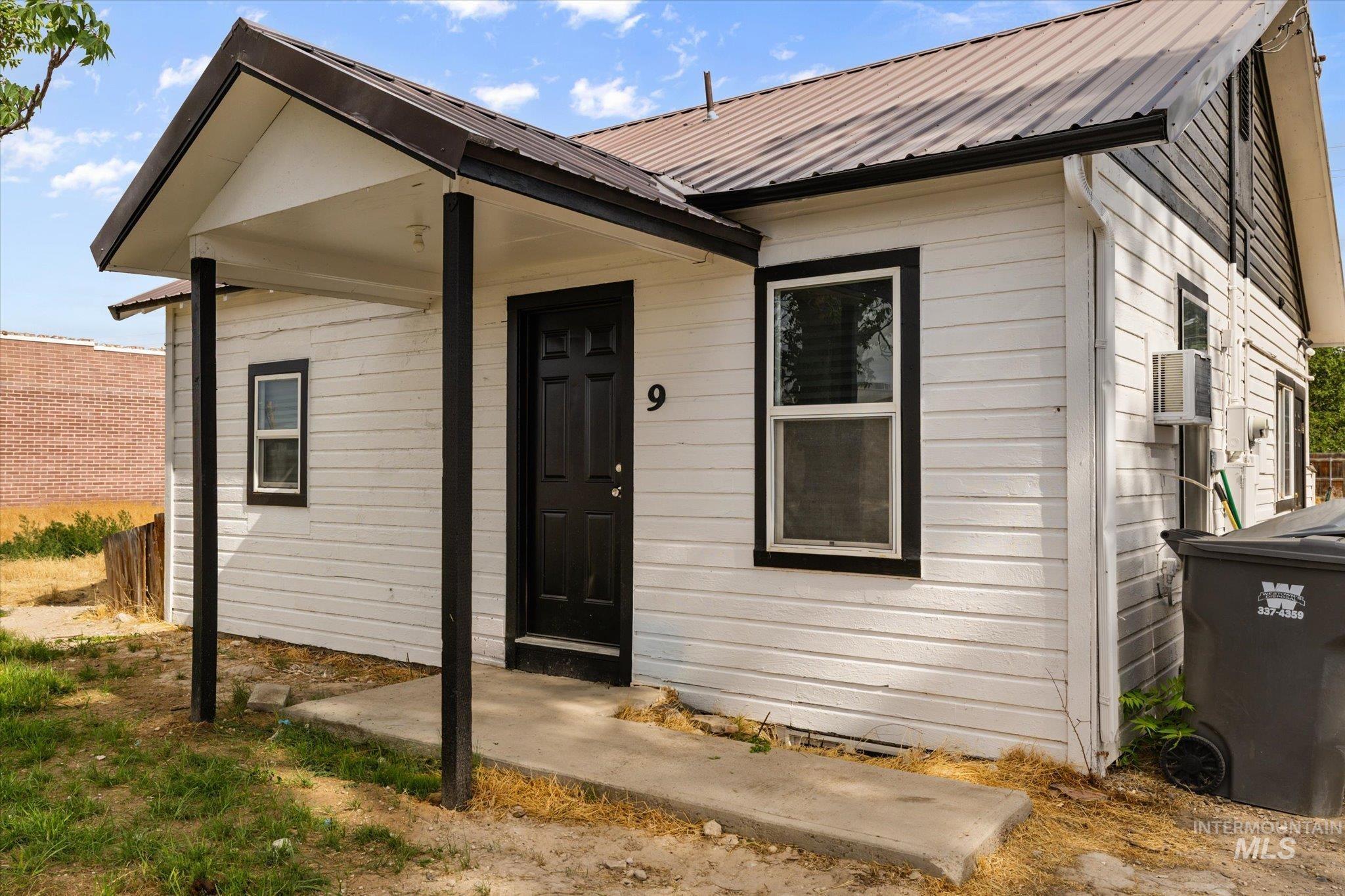 Entrance to property featuring a metal roof